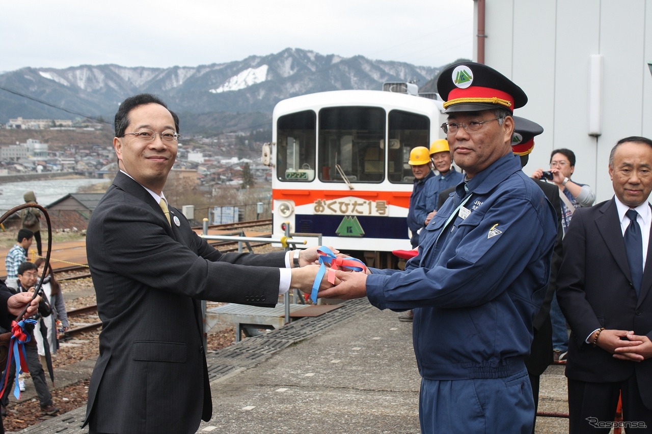 出発式では飛騨市長が運転士にハンドルを手渡した。