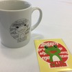 AOG湘南里帰りミーティング2016。毎年参加者に配られる記念品のマグカップ。今年の柄は公募された2016年のマスコットバージョンだ。ステッカーとともに。