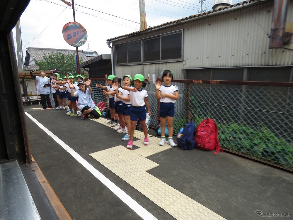 通過駅のホームで特別列車に手を振る地元の幼稚園児ら。
