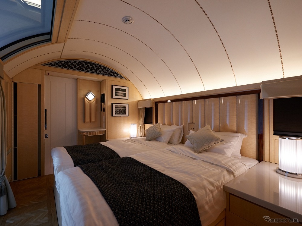 ザ・スイート：枕木方向に設置された寝室のベッド。通路を下にくぐらせているため、枕木方向でもゆったりとしたスペースを確保している。