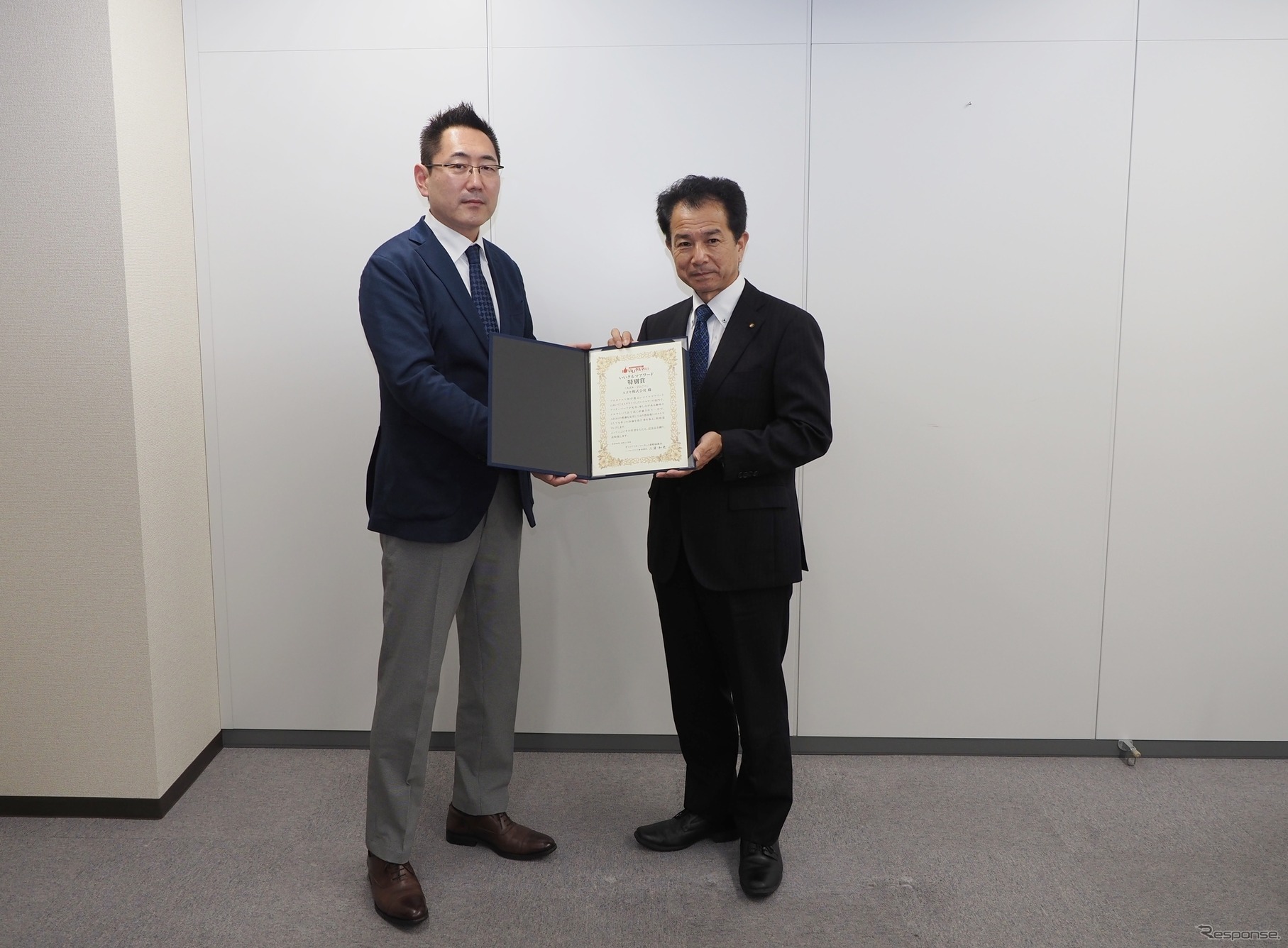 米澤チーフエンジニアに賞状を手渡す三浦選考委員長（左）