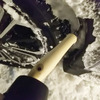 三菱 eKクロスEV 冬季1200km試乗前編：着氷を放置していると前輪の舵角を確保できなくなるので、適宜落とす必要がある。スコップの把手をゴムハンマーで叩いて氷を割るが効率が悪い。探せばおそらくげんのうのような、もっと便利な道具があると思う。