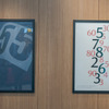 ポスターにもマツダのこだわりの数字が。右のポスターはぜひ近づいて見てもらいたい。5，7，8といった黒字の数字には……。