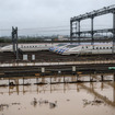 浸水した長野新幹線車両センターの北陸新幹線車両。赤羽大臣は電源設備なども含めて新幹線関連施設の浸水対策を早急に取りまとめるとしている。