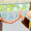 モンチッチとうれしそうにハイタッチする齋藤さん。