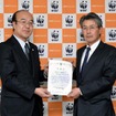 WWFジャパン樋口隆昌事務局長（左）より感謝状を受け取る横浜ゴム取締役常務執行役員の森田史夫