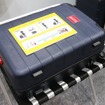 センサーメダルを設置したスーツケースのイメージ。あくまで応用例の展示なのでセンサーメダルは露出しているが、製品化する際には各メーカーが設置場所を工夫されるだろう（撮影：防犯システム取材班）
